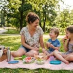 Mom and children enjoying a budget family picnic at the park